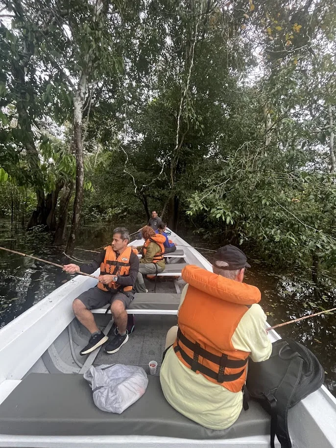 Hóspedes em passeio de canoa pela floresta amazônica